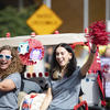 Two Division Employees help to celebrate Homecoming during the annual Golf Cart Parade